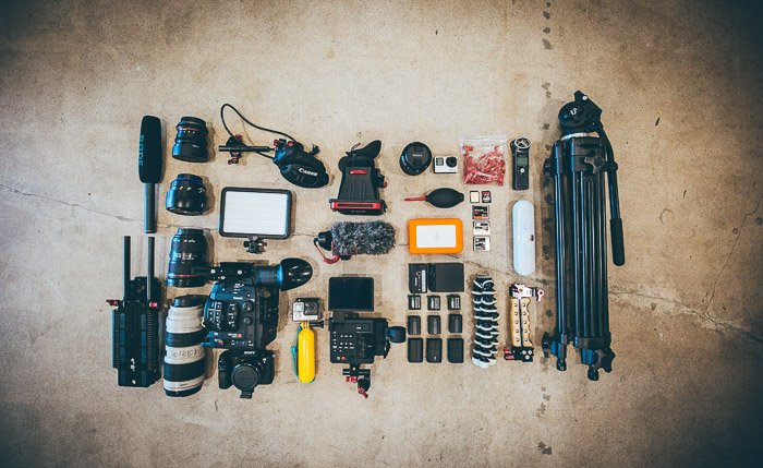 Flat lay of various camera accessories on a concrete surface
