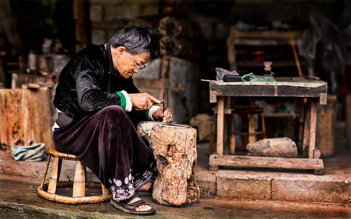 A portrait of a Hmong blacksmith at work created using the brenizer method