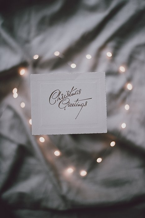 Heart shaped Christmas bokeh lights in the background of a greeting card