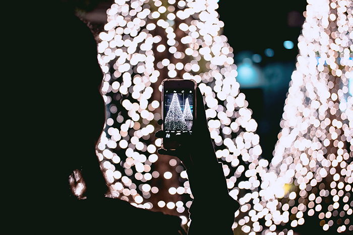 Taking a smartphone photo of a Christmas tree