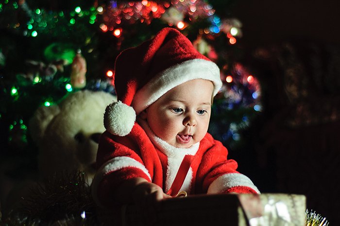 Christmas portrait of a little baby in a santa hat