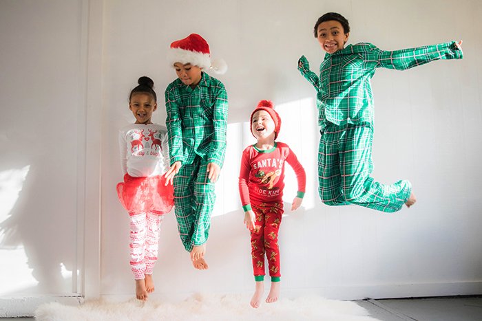 Christmas portrait of four kids jumping