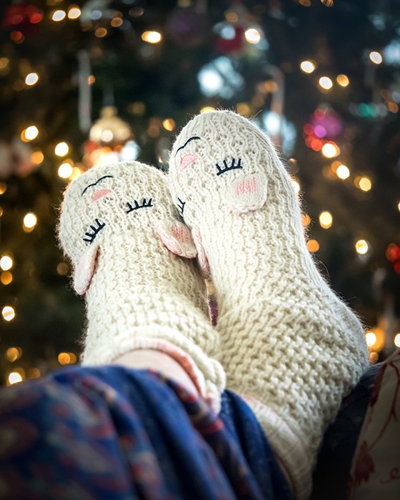 The feet of someone wearing christmas socks