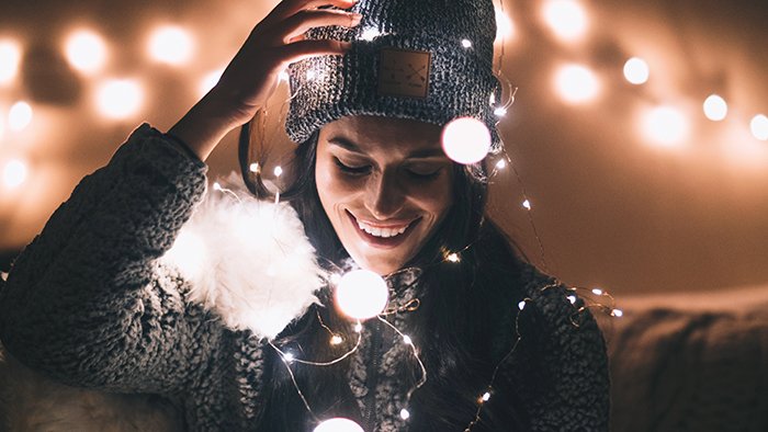A girl posing indoors with christmas lights and beautiful bokeh effects