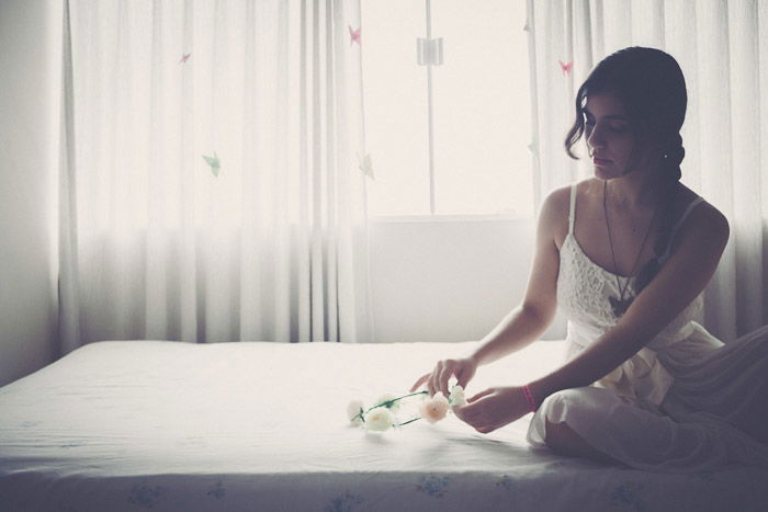 Bright and airy glamour shots of a female model posing on a bed