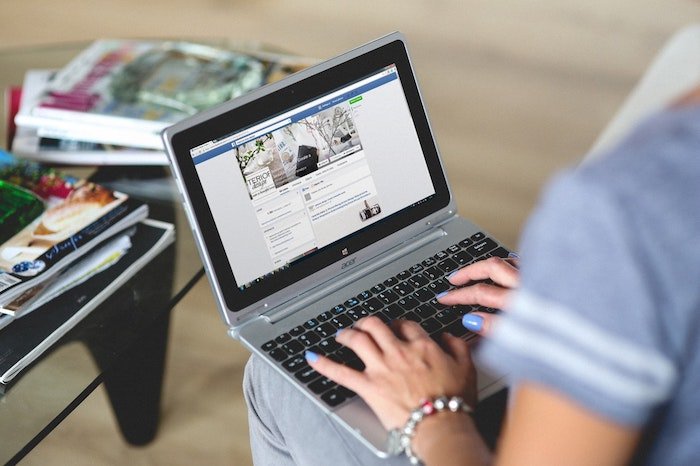 A photo of a person resizing images on a laptop for facebook