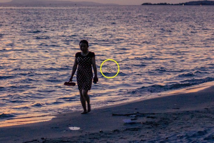 Screenshot showing how to photoshop someone out of a picture using a photo of a woman walking on a beach at evening time