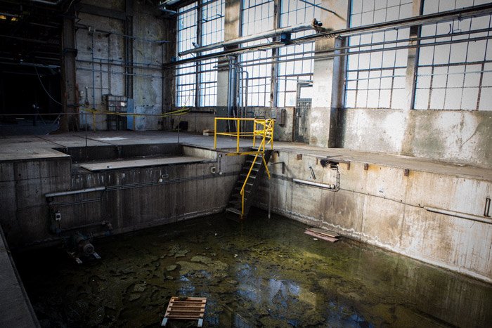 An industrial photography shot of a waste pool inside a building 