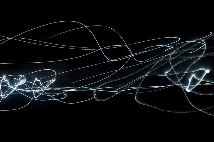 Abstract photo of light trails against black background 