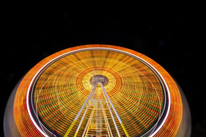 Time-lapse image of a ferris wheel at night