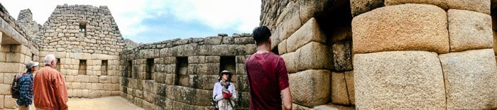 Interesting panoramic pictures of tourists observing an ancient stone building 