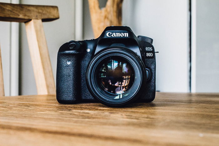 A Canon DSLR resting on a table