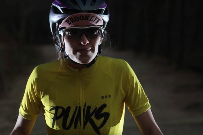 A portrait of a female athlete in low light