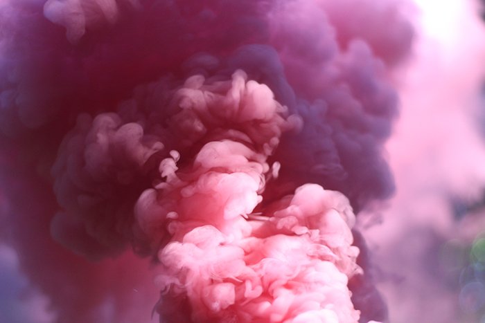 close up of billowing pink smoke grenades
