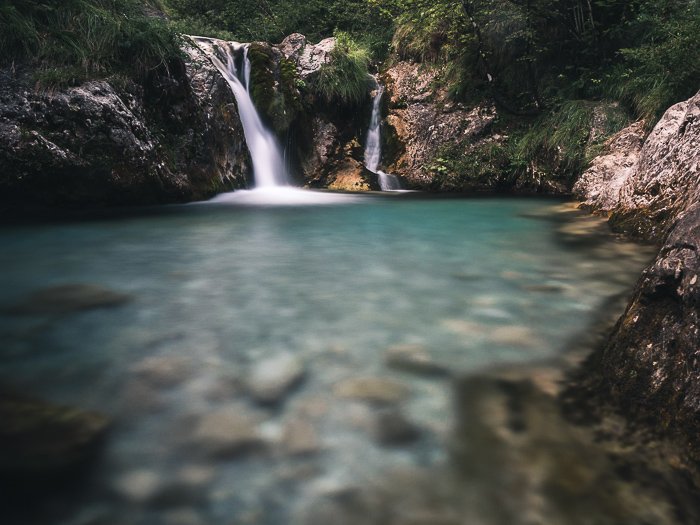 A summer photography shot of a waterfall in Val Vertova