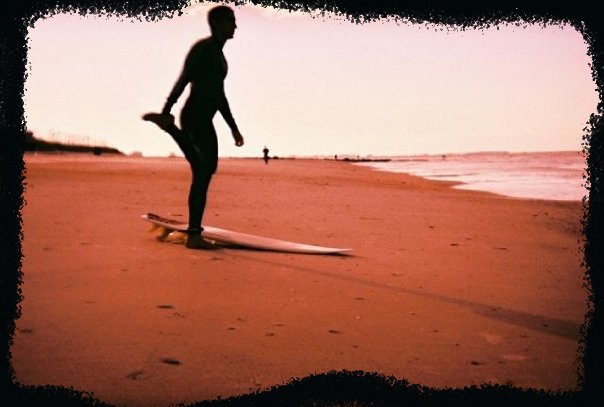 An image of a surfer on a beach with a hand painted Photoshop border