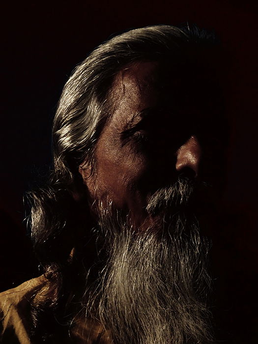 Atmospheric portrait of a male model shot with chiaroscuro lighting