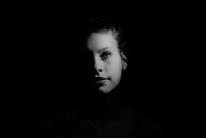 Atmospheric portrait of a female model shot with chiaroscuro lighting