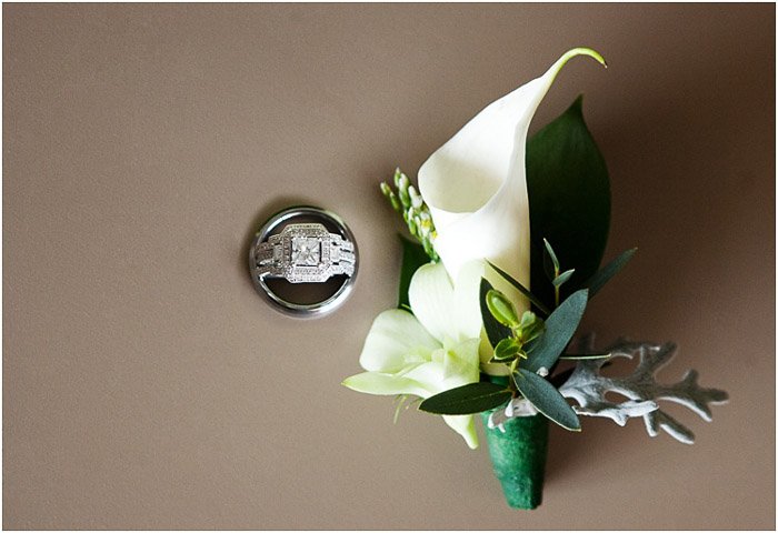 Wedding photography flat lay of an orchid beside a ring