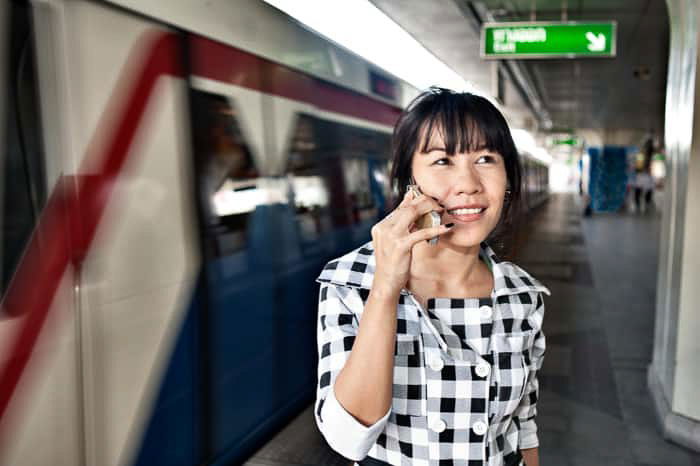 A flash photography portrait of a woman on her smartphone