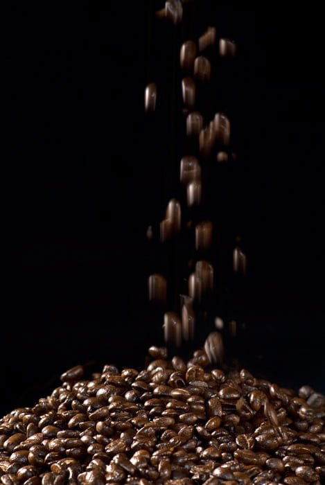 Flash photography shot of Falling Coffeee Beans against a black background