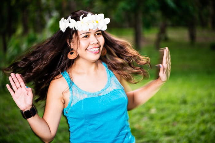 A flash photography portrait of a woman dancing outdoors 