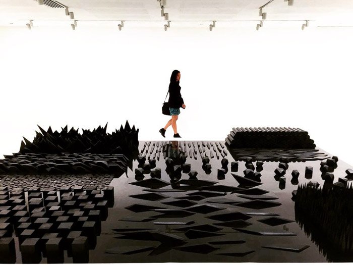 A photo of a girl looking at an art installation shot using iPhone camera