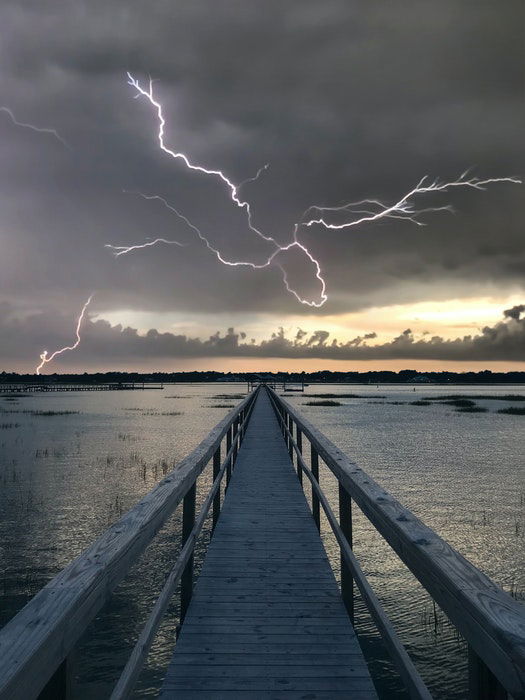 Forked lighting striking over a city at night