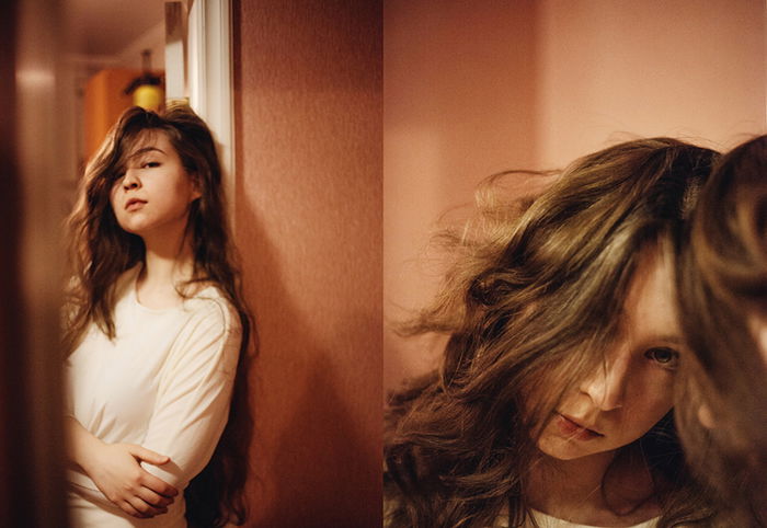 A diptych portrait of a brunette female model reflected in a mirror 