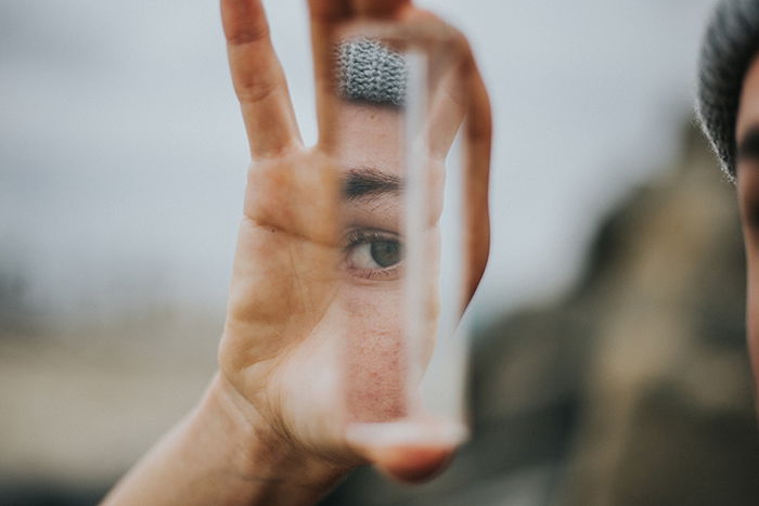 An abstract portrait of an eye reflected in a mirror