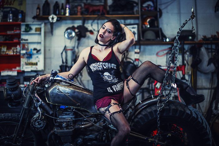 Cool motorcycle photography portrait of a female model posing on a bike