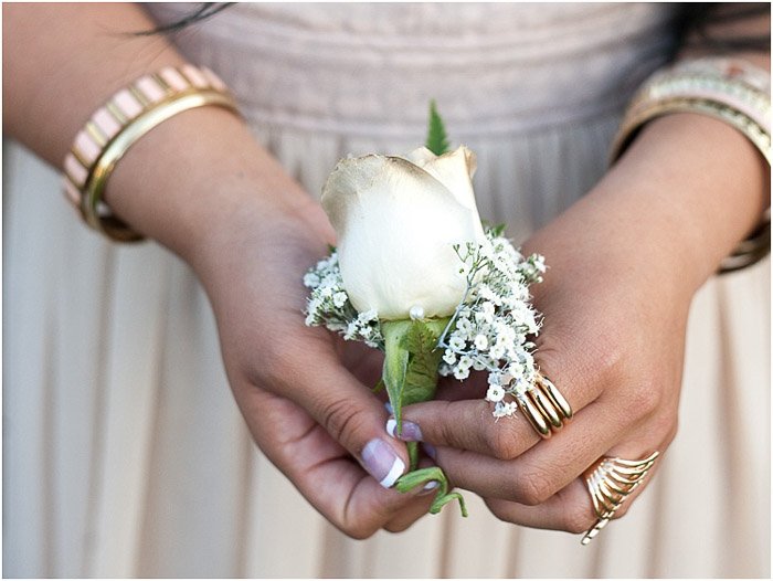 prom picture poses- close up of a teen girl holding a corsage flower