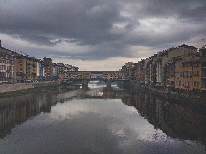 Reflection of a cityscape in a river in Florence, Italy
