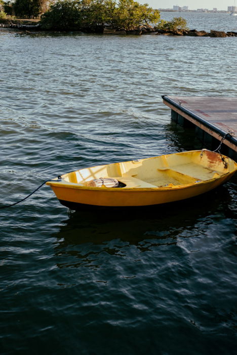 a bright yellow boat on clear deep blue waters