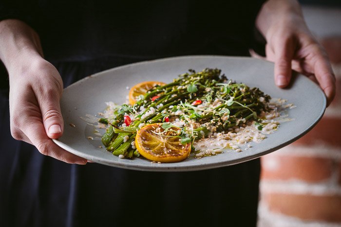 Food photography shot of a person holding a plat of salad and rice