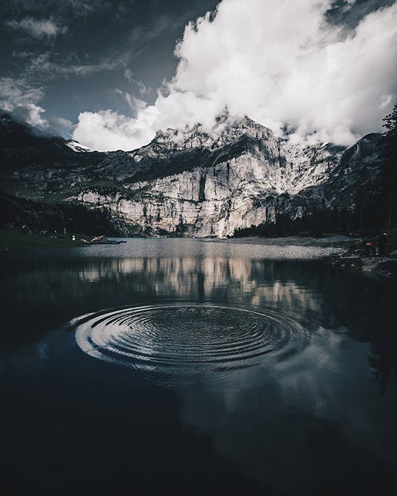 Atmospheric mountainous landscape with a lake adding reflection and depth - symmetry in photography 