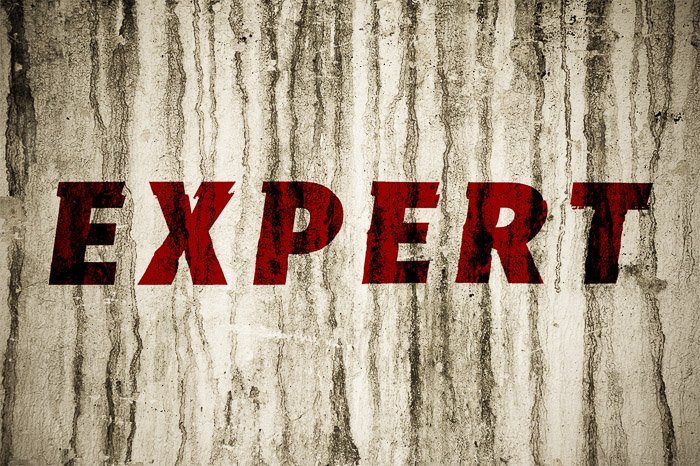 A textured grunge wall with the word 'expert' in red - using displacement map photoshop