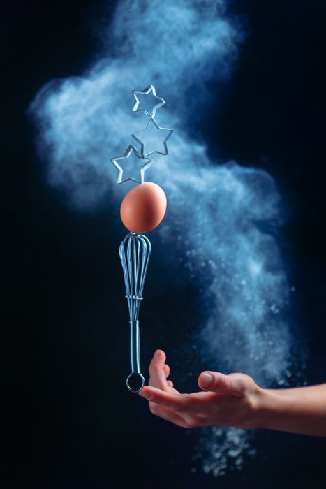A cool still life shot using flying kitchen utensils and flour clouds - creative still life photography