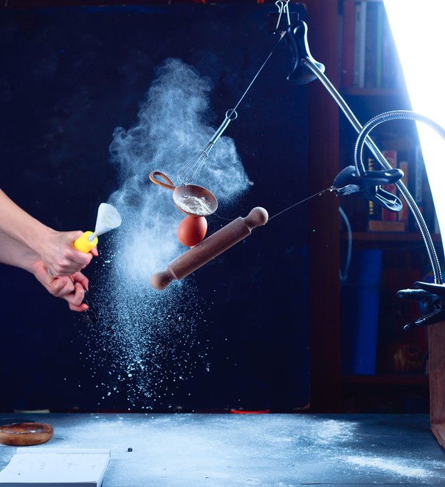Setup of shooting a still life using flying kitchen utensils and flour clouds - creative still life photos