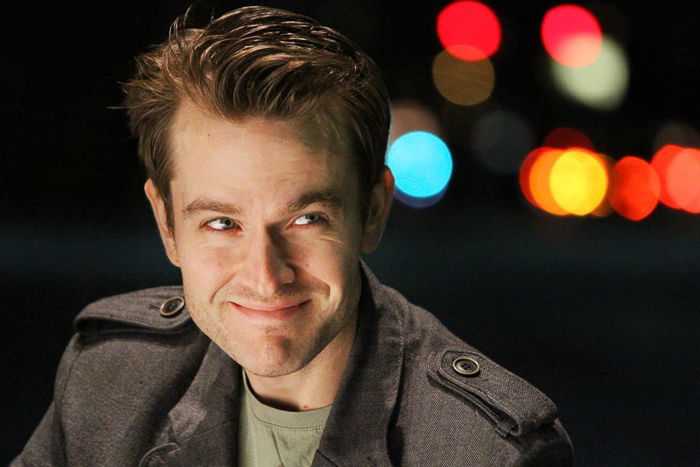 A male model posing for an atmospheric night portrait photography shot