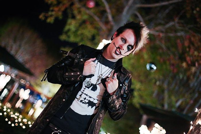 A male model in goth gear posing for night portrait photography