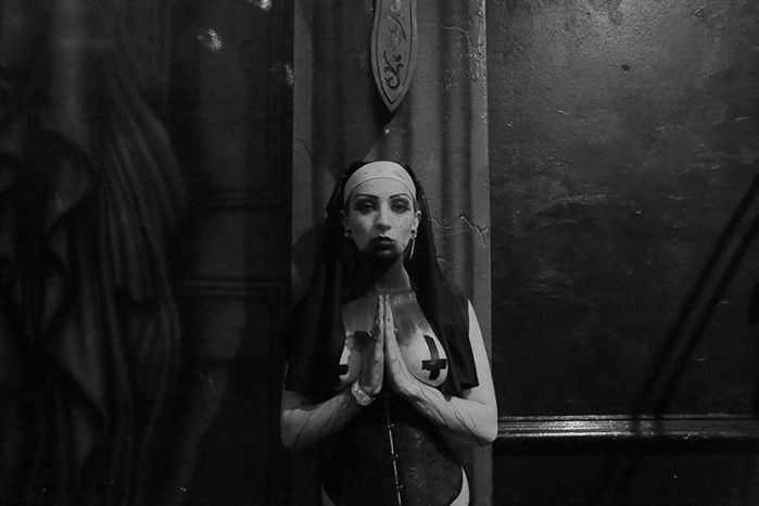 Atmospheric nightclub photography portrait of a female clubber in gothic style dress 