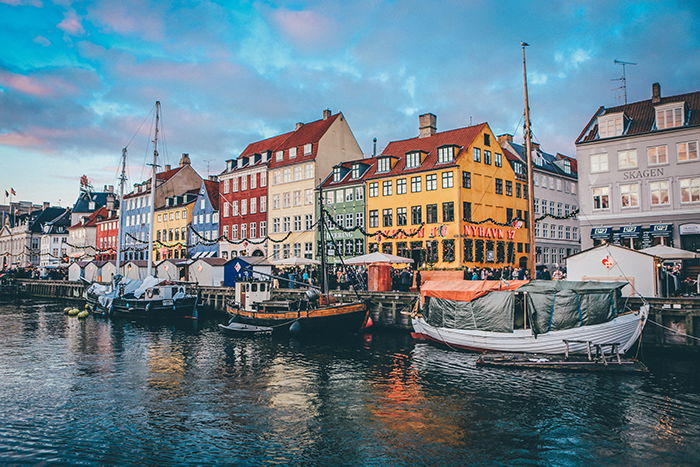 Colored house and boats by the river in Copenhagen - most beautiful cities in the world