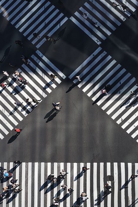 An overhead shot at people walking at a pedestrian crossing 