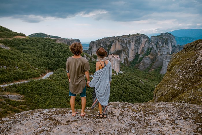 A candid photography example of couple holding hands in a picturesque landscape