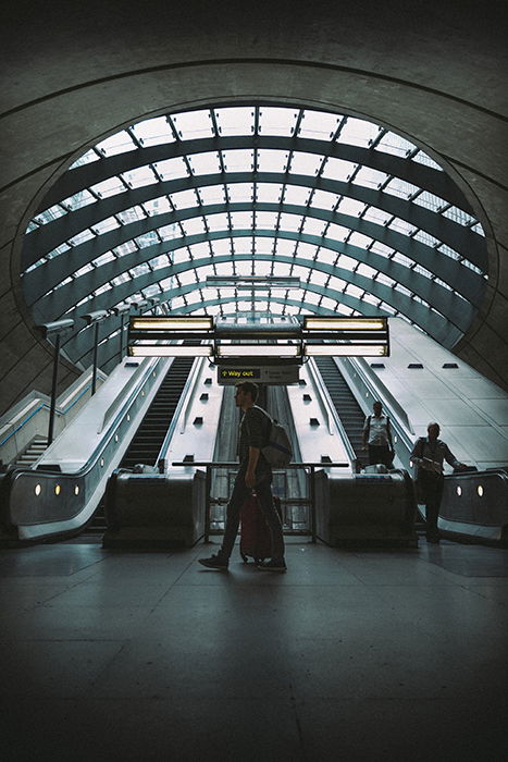 A candid shot of people walking down an escalator 