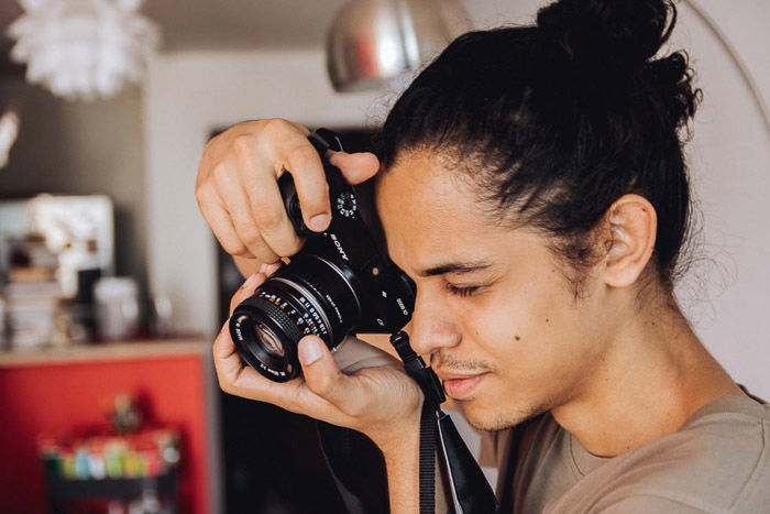 A photographer shooting through a Sony dslr camera