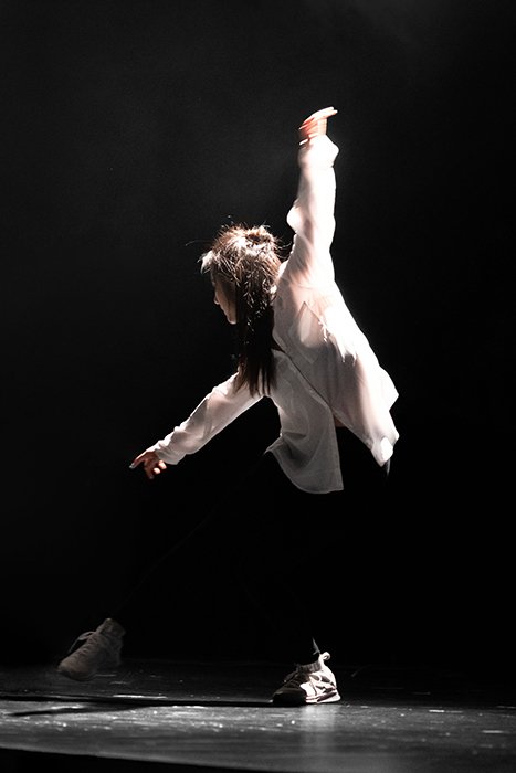 Atmospheric dance photography shot of a female dancer mid performance