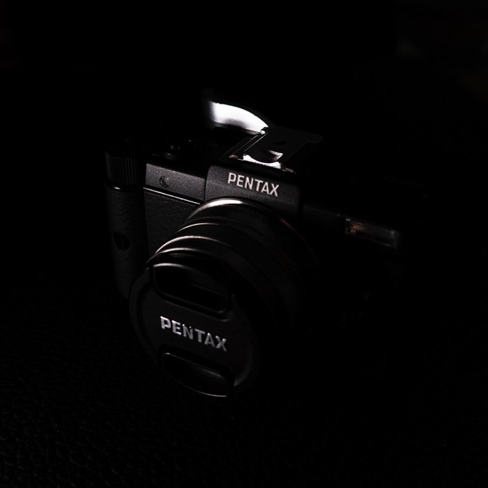 A Pentax camera on a black background - how to make a photo booth