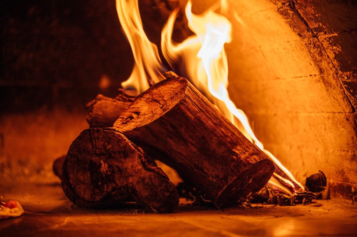 Zoomed in close-up of a log fire in an indoor fireplace for fire photography